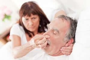 Woman trying to stop husband's snoring